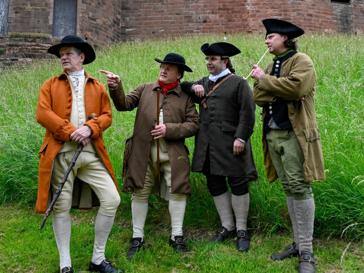 Four men in 1770s civilian dress outside a fort