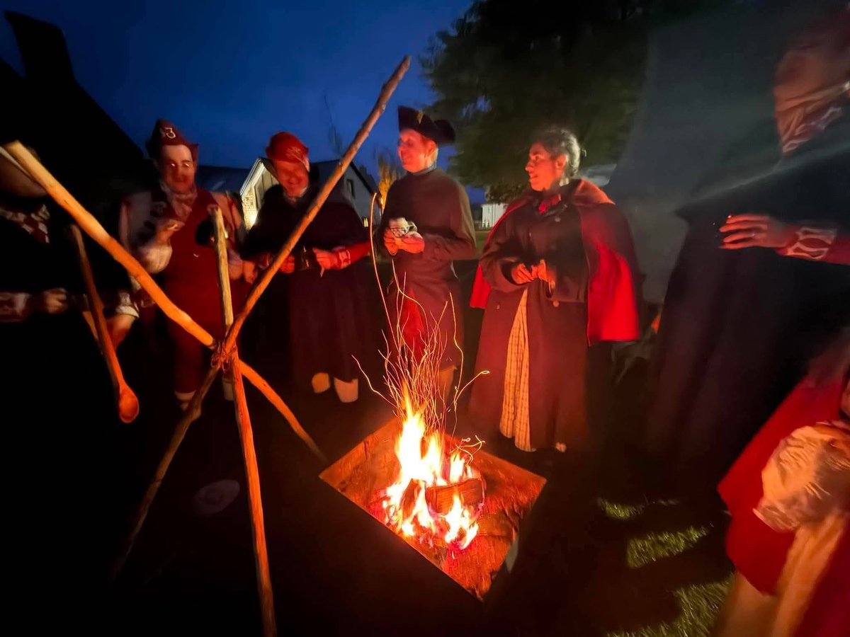 Soldiers and followers of the 33rd around a campfire at night
